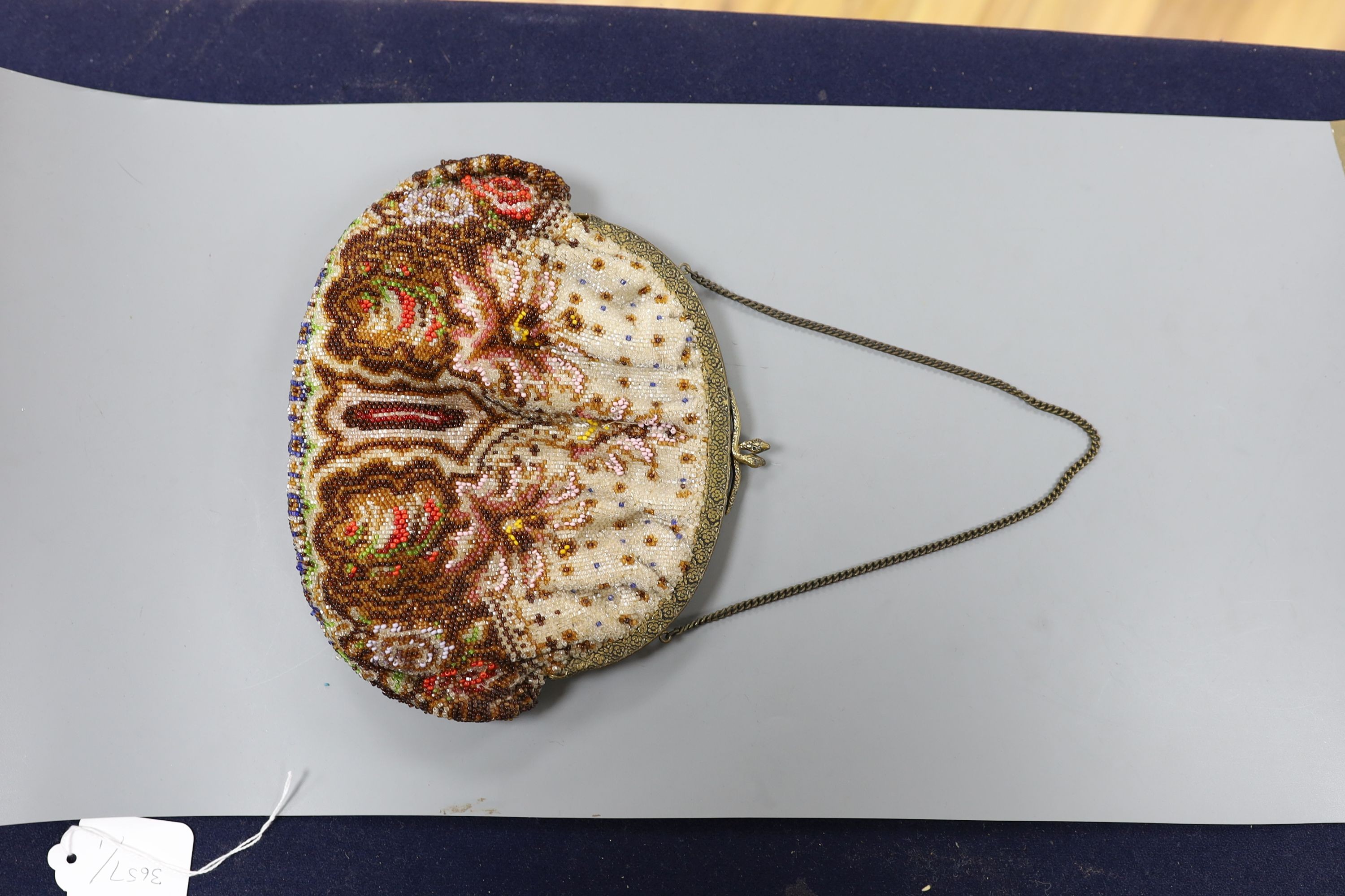 A fine needlework petit point evening bag, a 19th century bible bag, an early 20th century beaded bag and a 1930's beaded bag